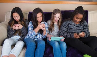 Group of kids on their mobile device