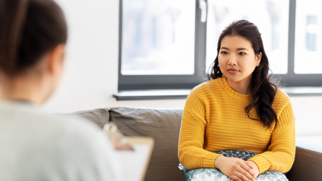 woman in yellow sweater on couch