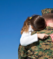 Military Father Hugging His Daughter With An American Flag